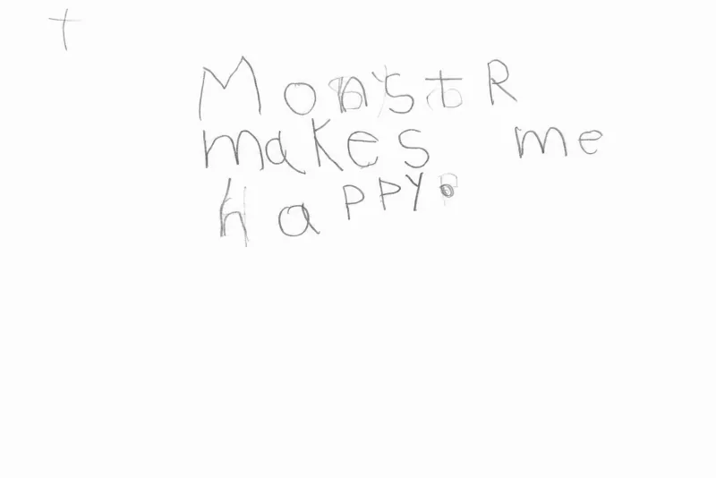Pencil handwriting by a young child that reads “Monstr makes me happy”.